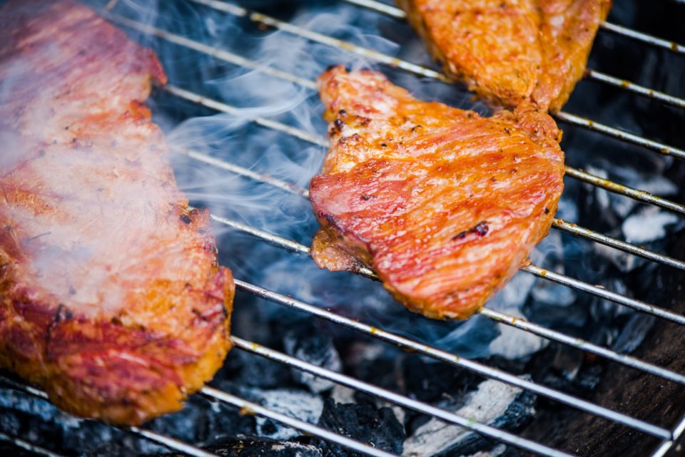 Close up view on meat on bbq hot grid grilling