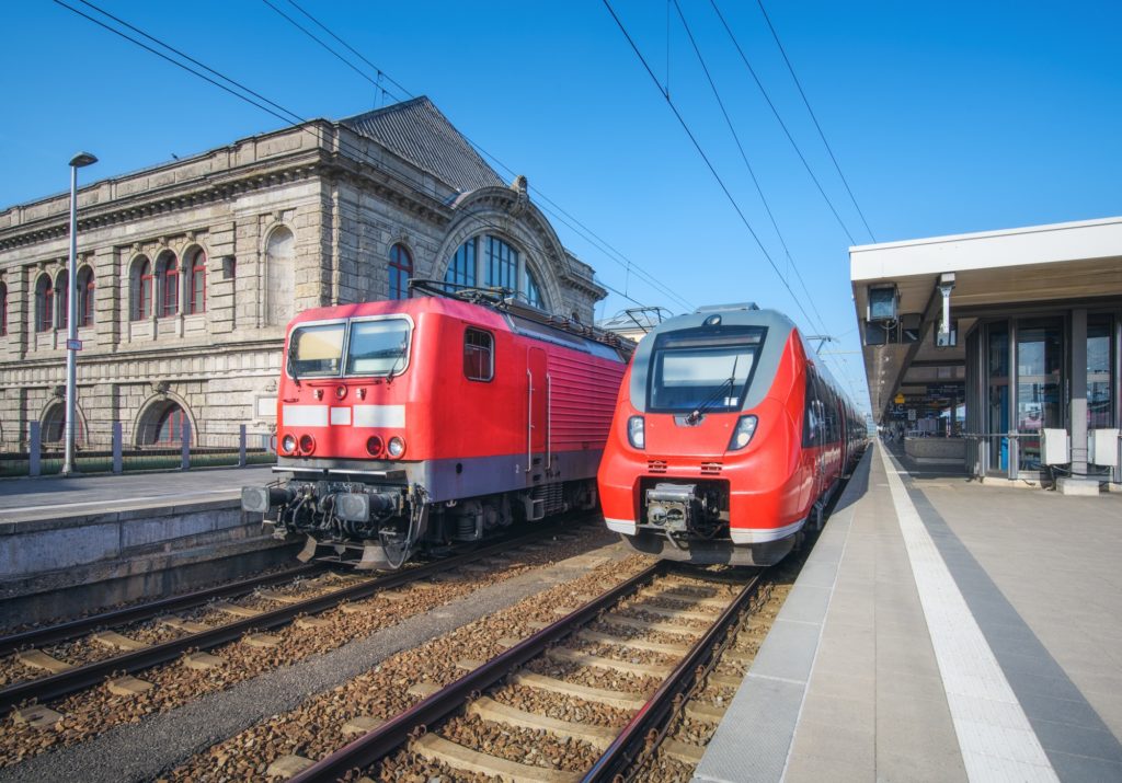 High speed train and old train on the railway station