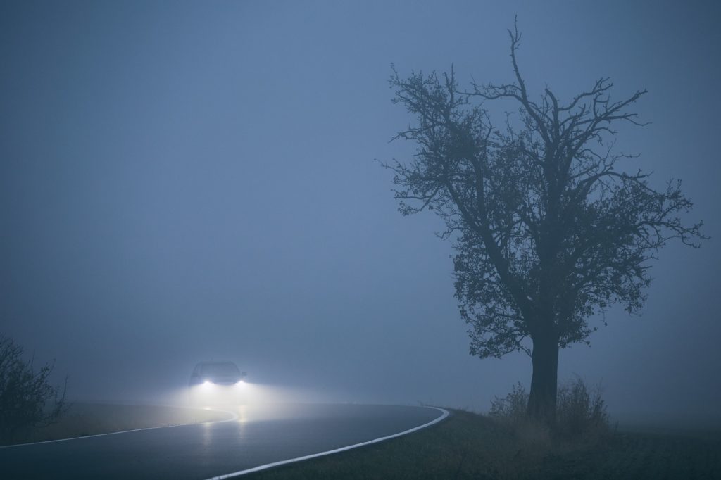 Car in thick fog