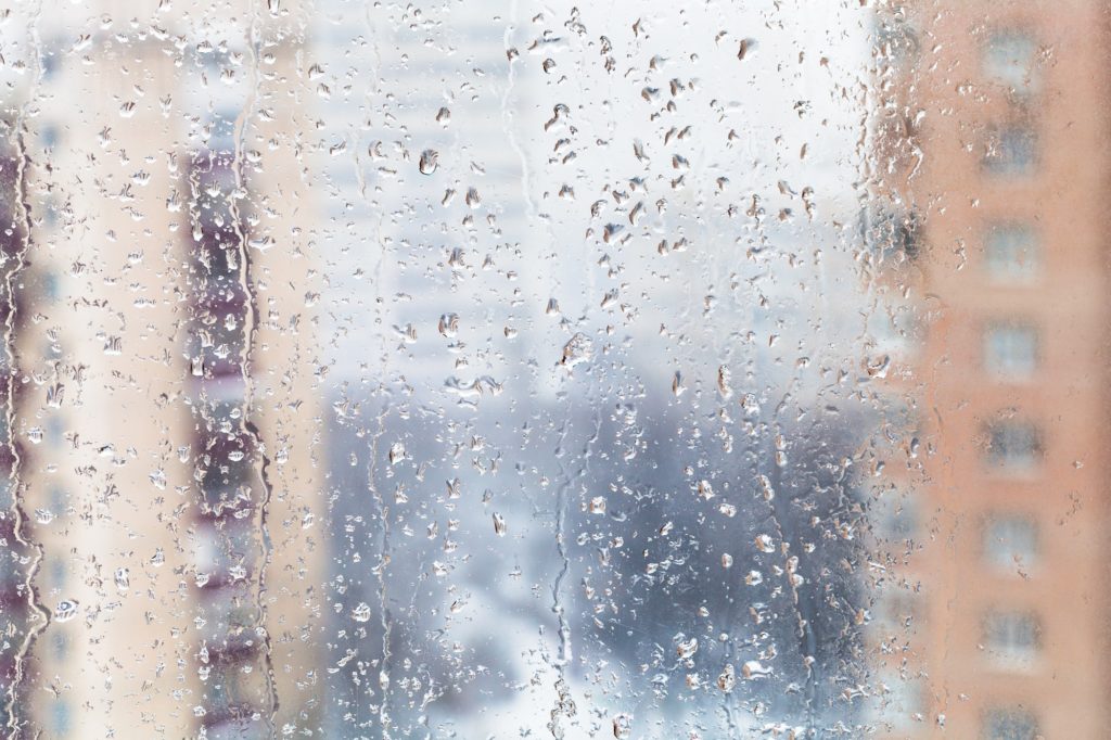 rain drops on home window glass in winter