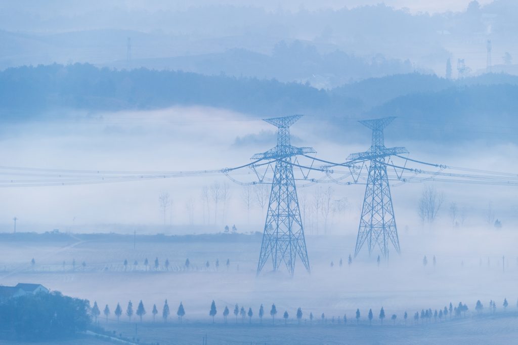 power transmission towers in the morning fog