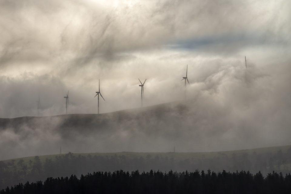 Wind turbines of a wind farm in the fog