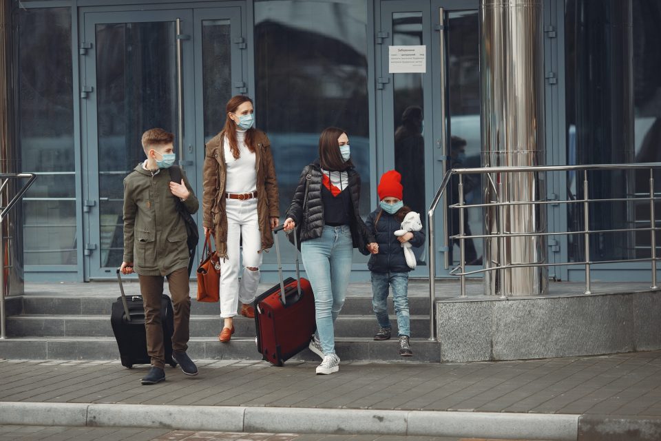 Travelers leaving airport are wearing protective masks