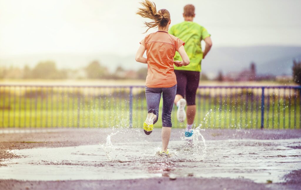 Couple running in rainy weather