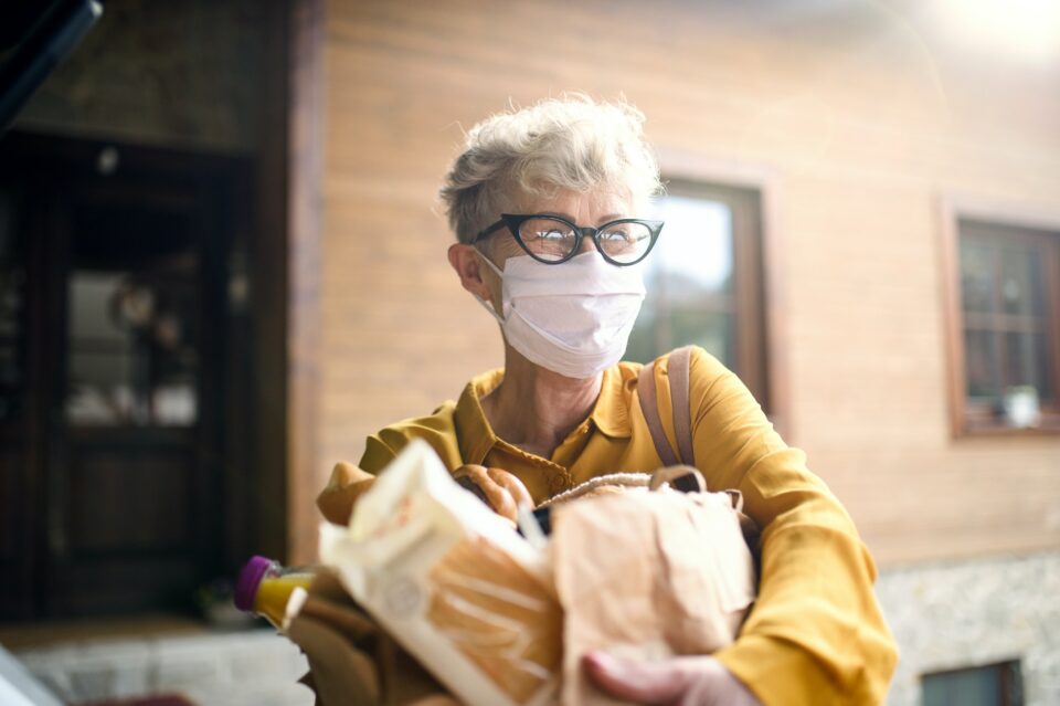 Senior woman with face mask outdoors with shopping, corona virus and quarantine concept