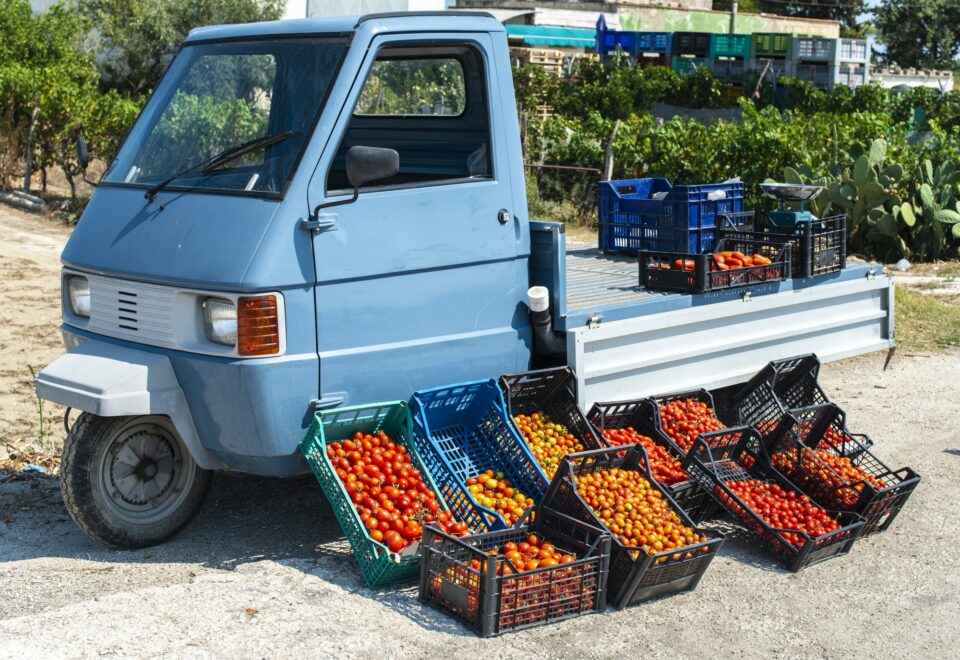 Small italian apo truck with tomatoes. Farmer sale tomatoes on t