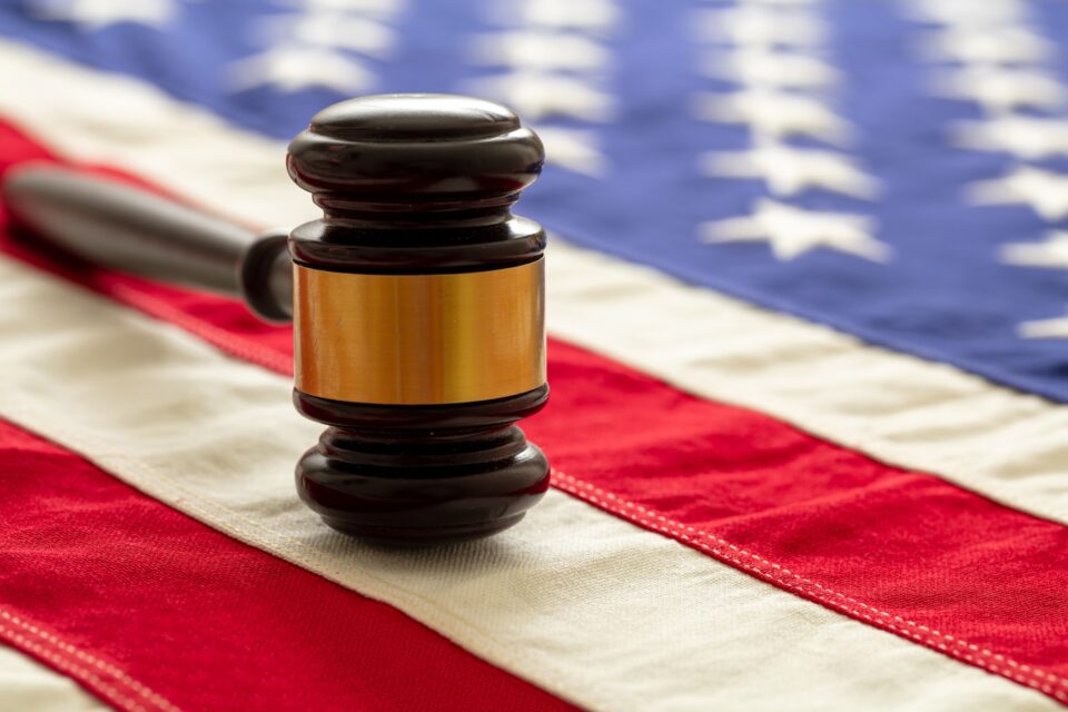 Justice in USA. Law gavel on United States of America flag.