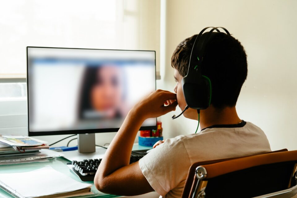 Teenager is studying at home attending online classes during the coronavirus COVID-19 pandemic