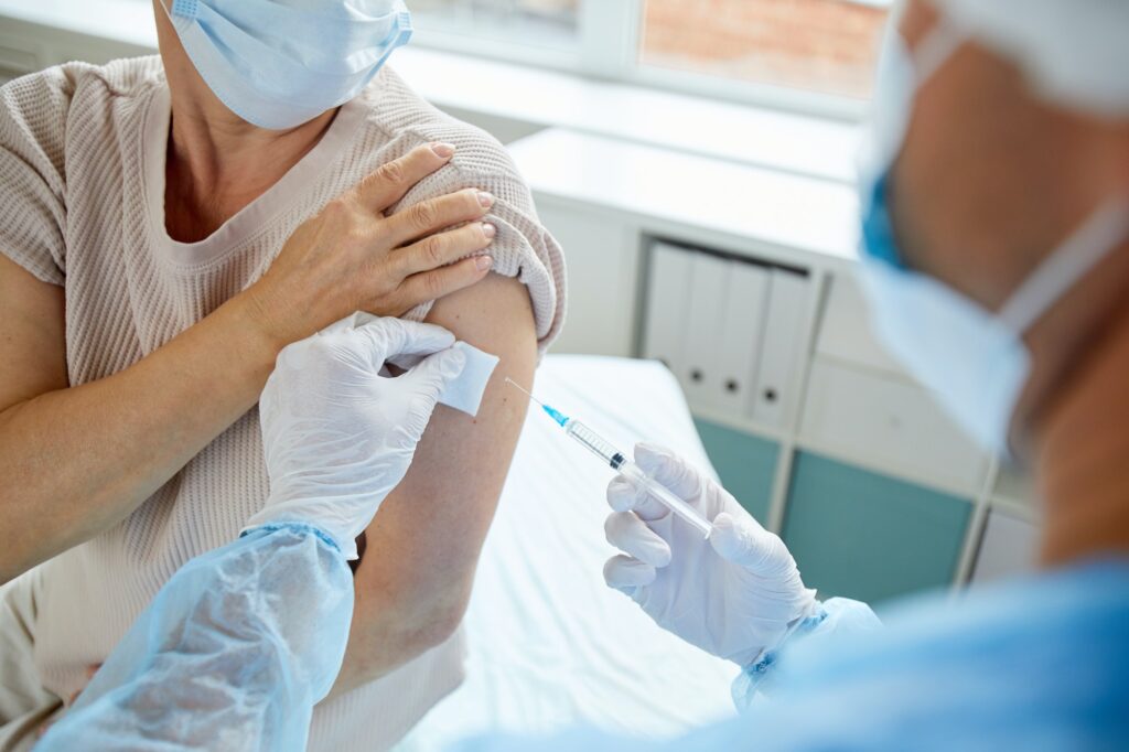 Giving Vaccine To Woman