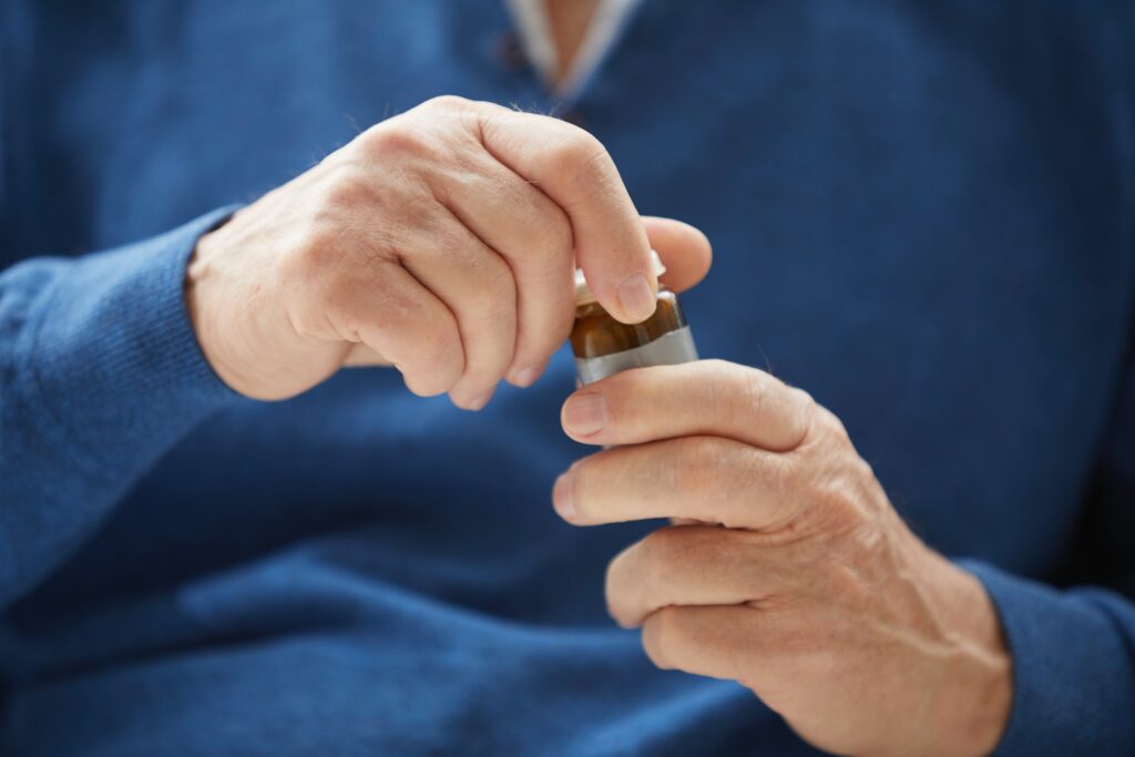 Senior Man Holding Pill Bottle