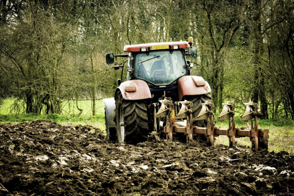 Agricultural tractor ploughing field
