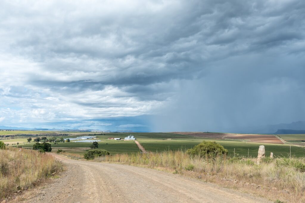 Gravel road, Bloukruin Manitoba farm and thunderstorm near Fouriesburg