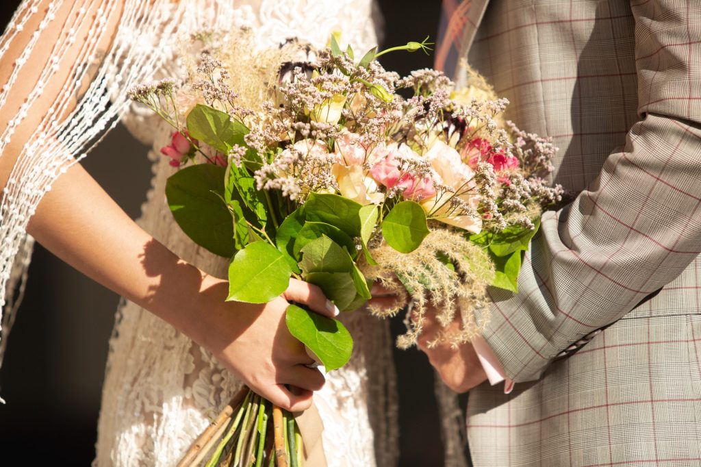 Caucasian romantic young couple celebrating their marriage in city