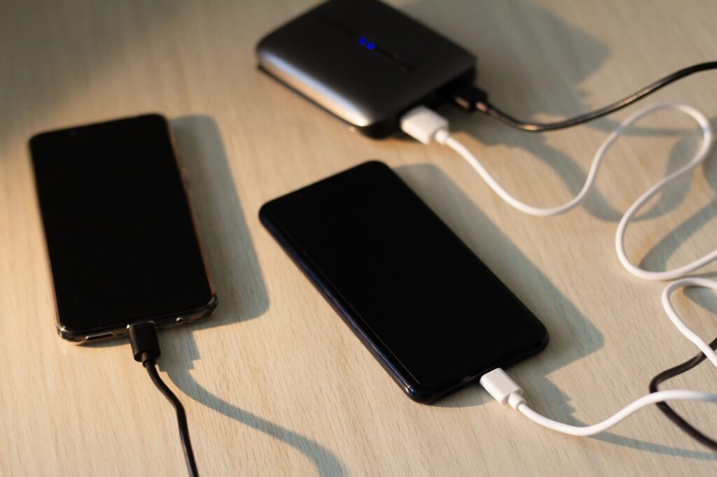 Charging your smartphone from a portable charger, close-up.