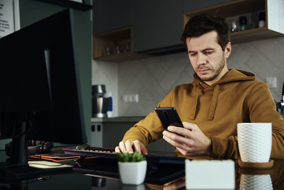 Man working at home office and use smartphone