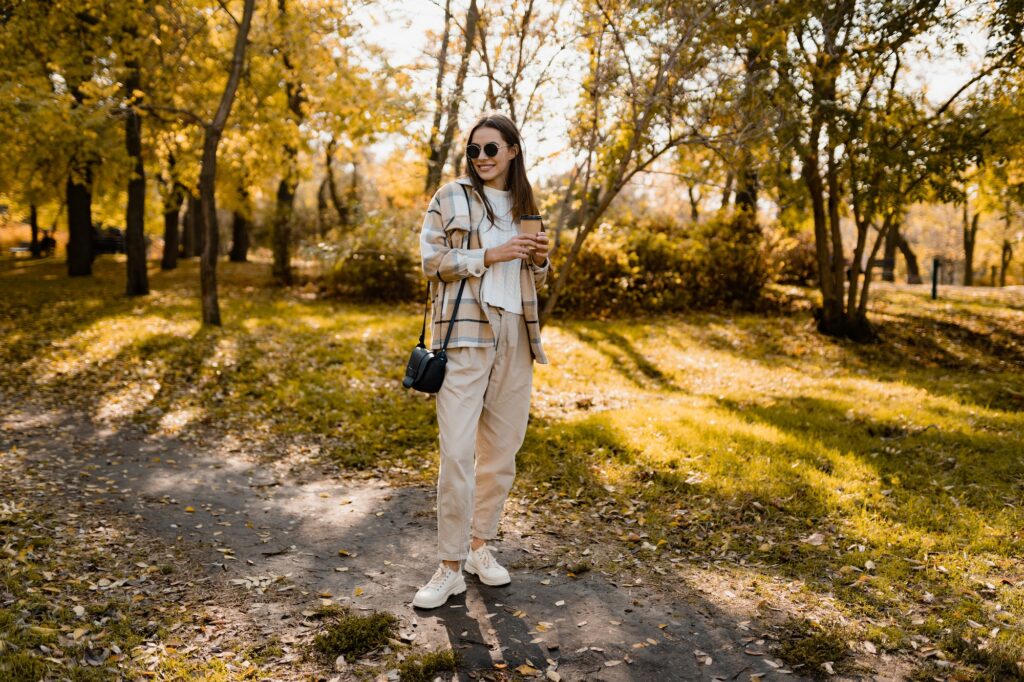 attractive young woman walking in autumn wearing jacket