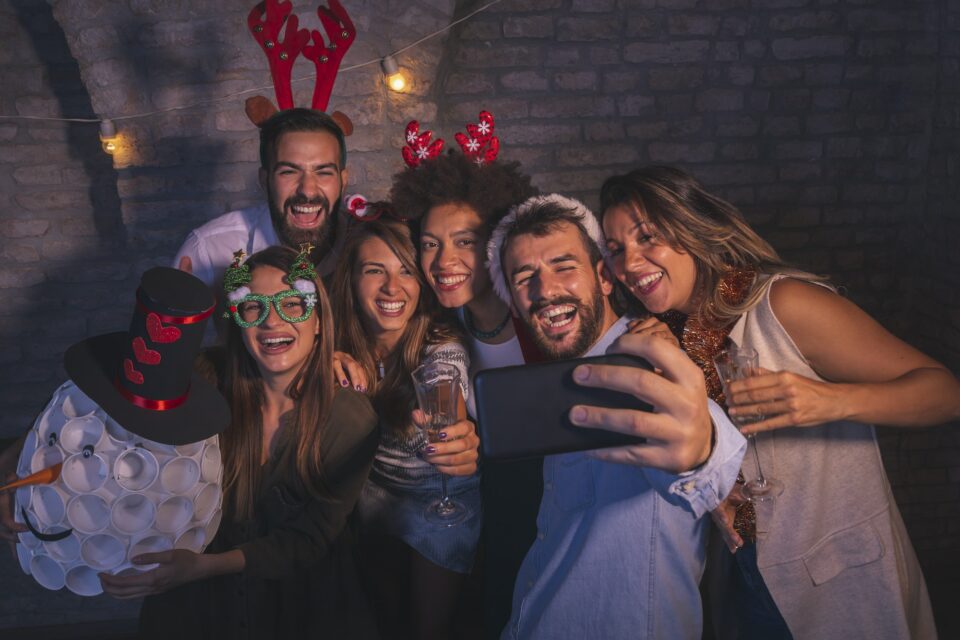 Friends taking selfies at New Year's Eve party