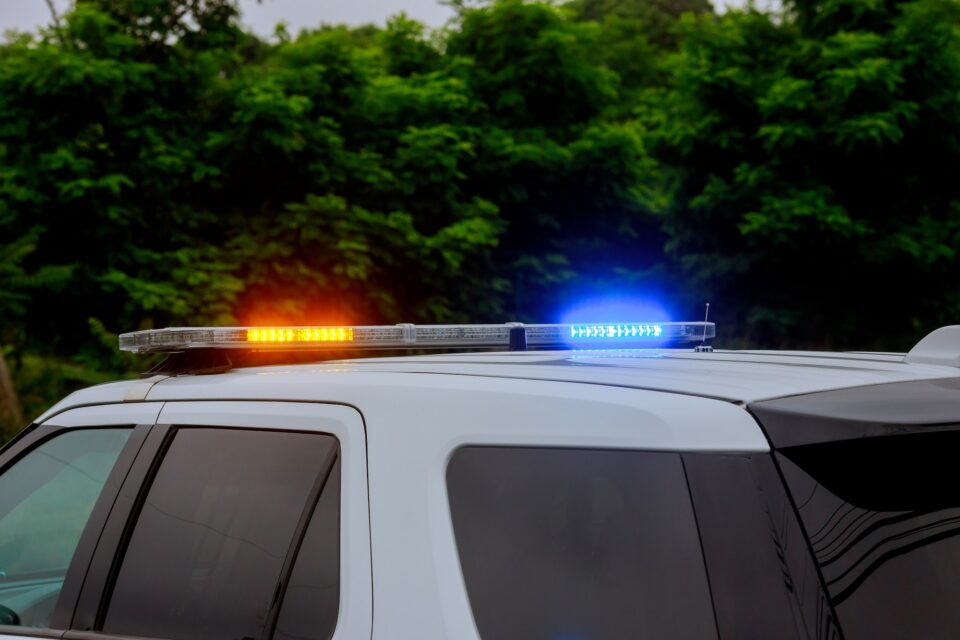 Blue and red flashing sirens of police car during the cruiser flashing red and blue emergency lights