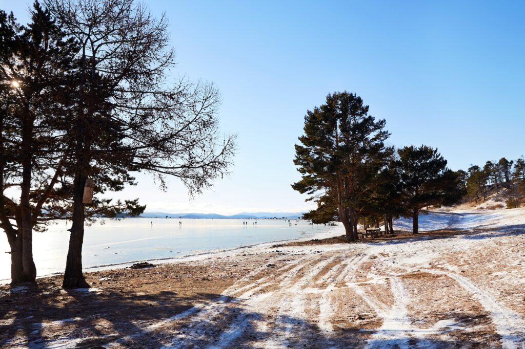 Beautiful winter landscape, the shore of frozen Lake Baikal on a sunny January day.