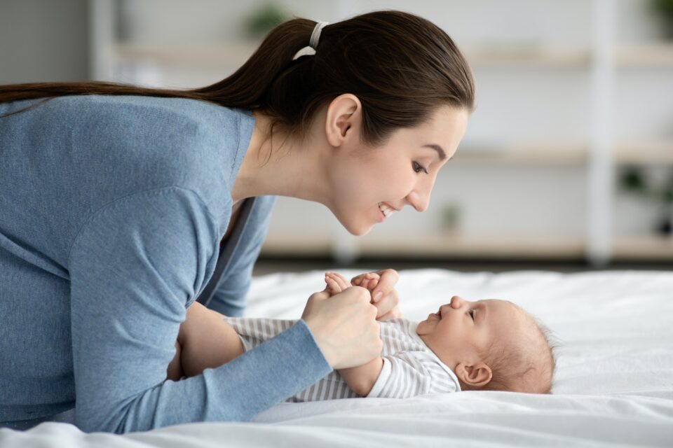 Mother-Child Connection. Happy Loving Young Mommy Bonding With Newborn Child At Home